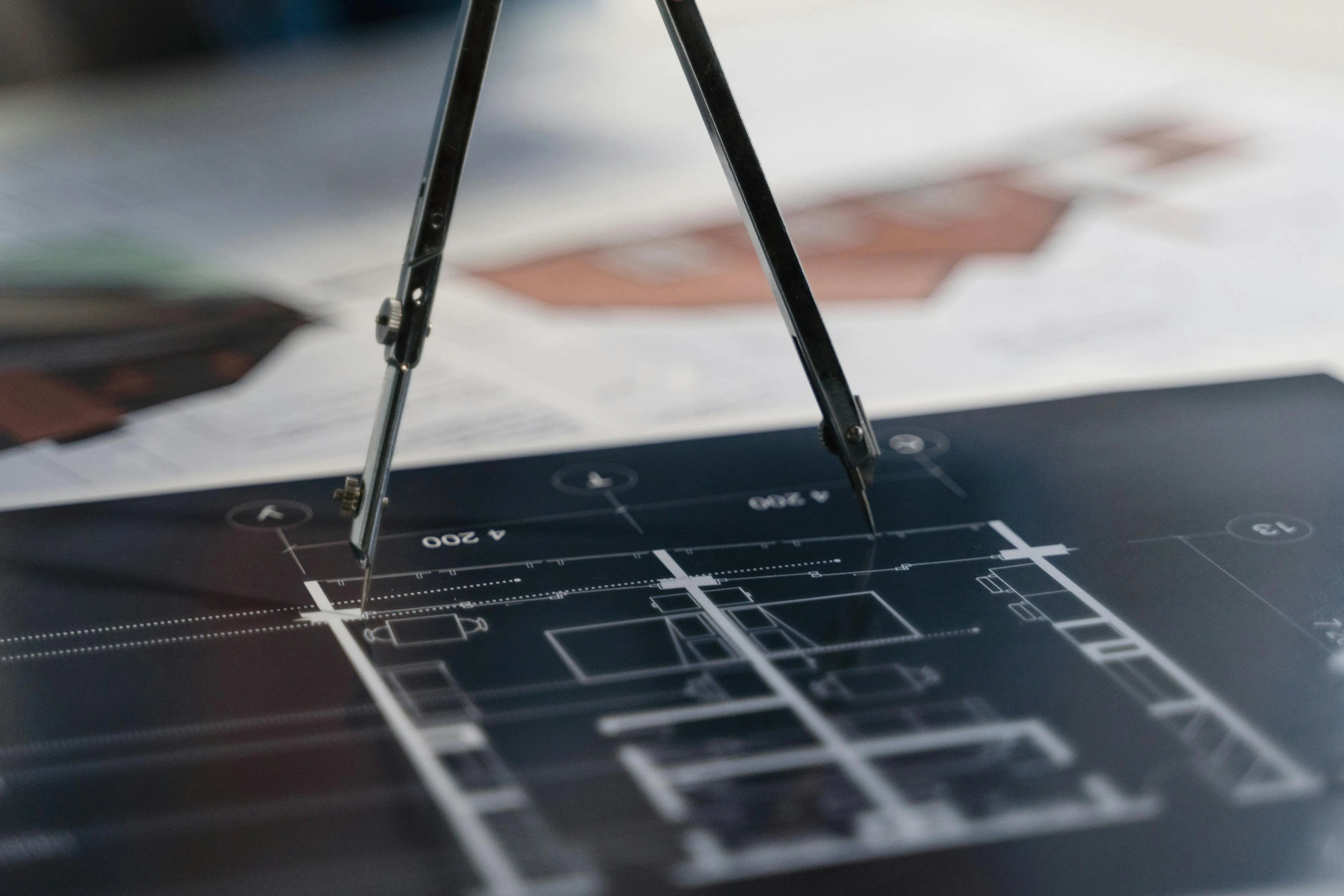 A compass charting out a blueprint
