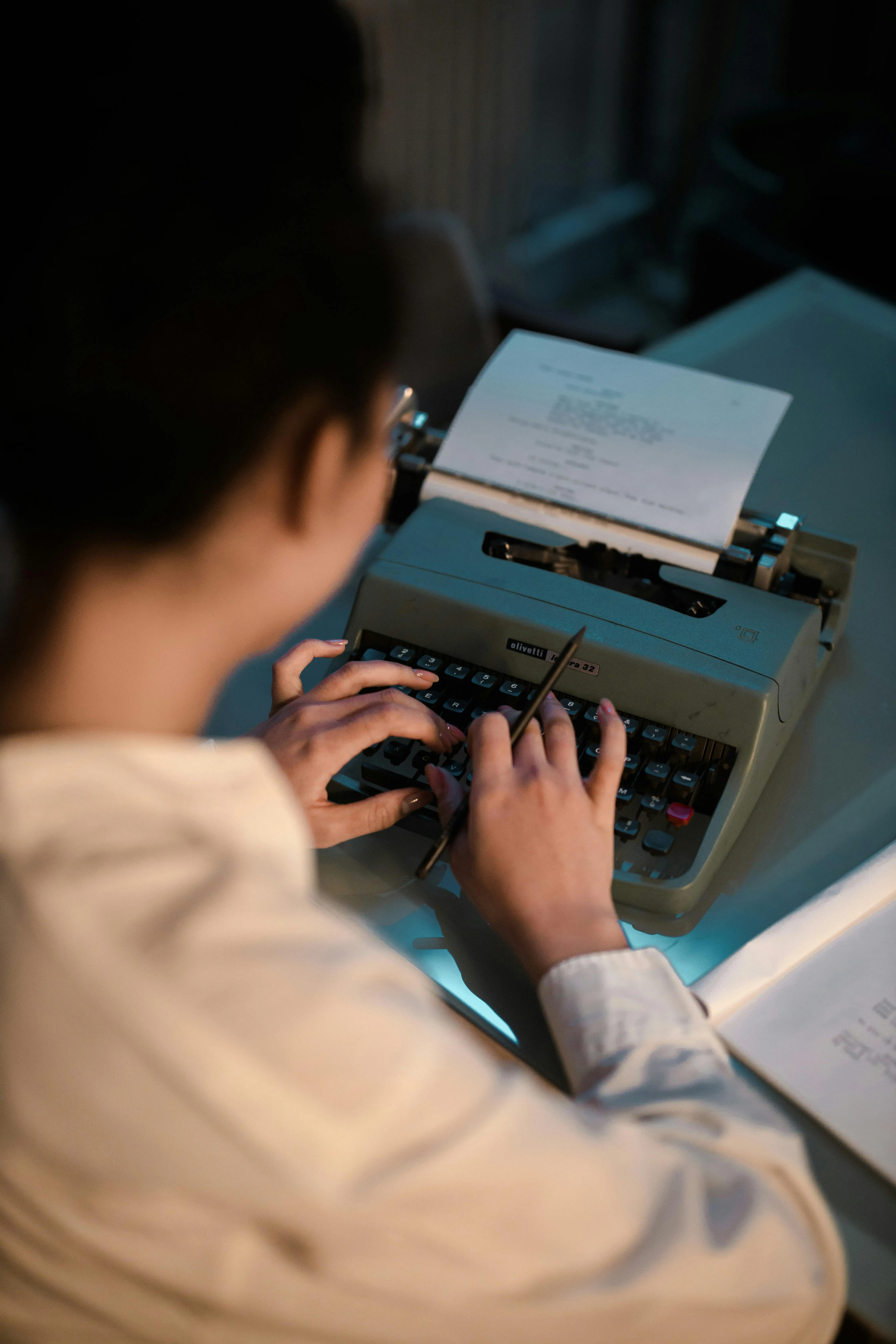 A human typing at a typewriter