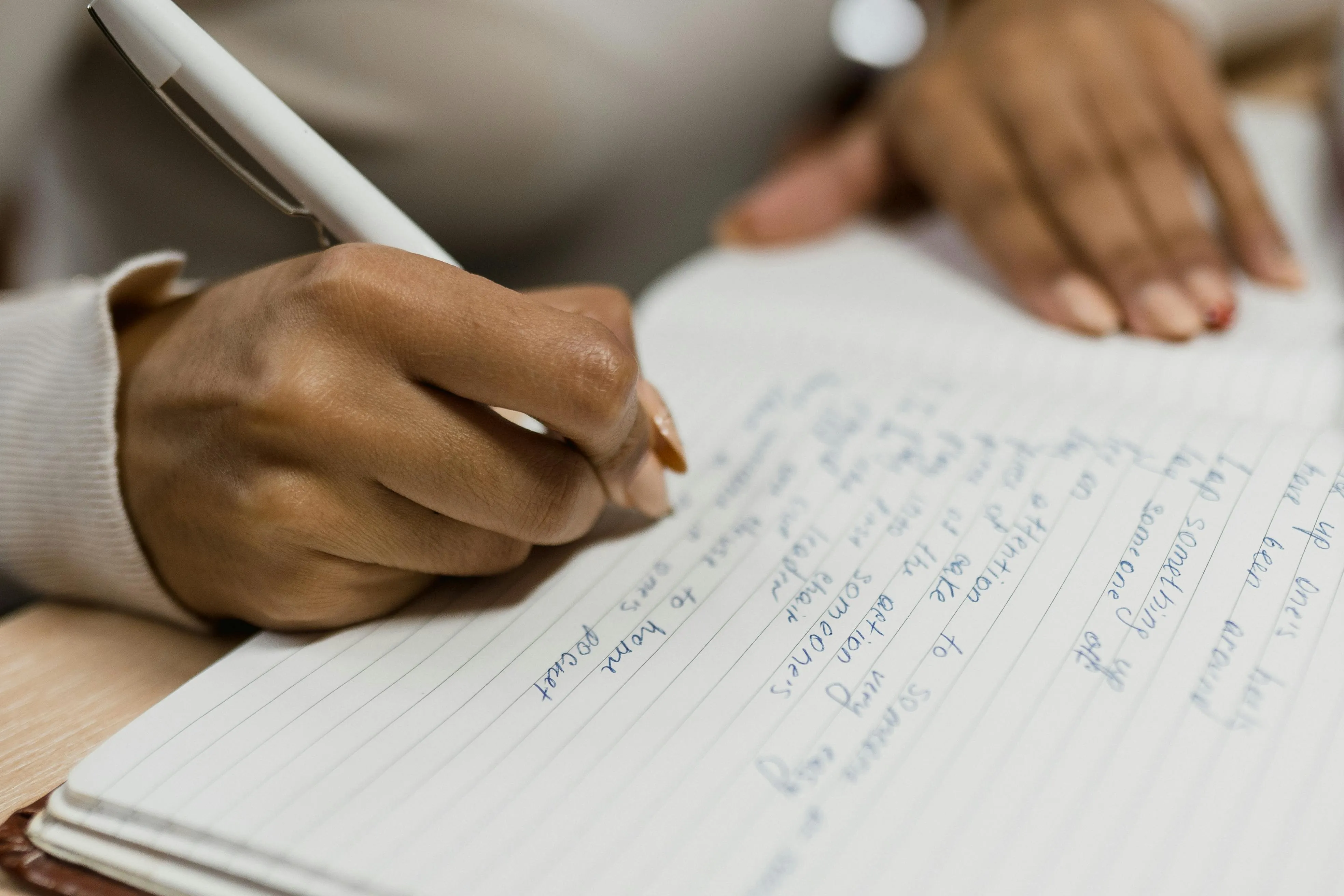 A person writing notes in a notebook