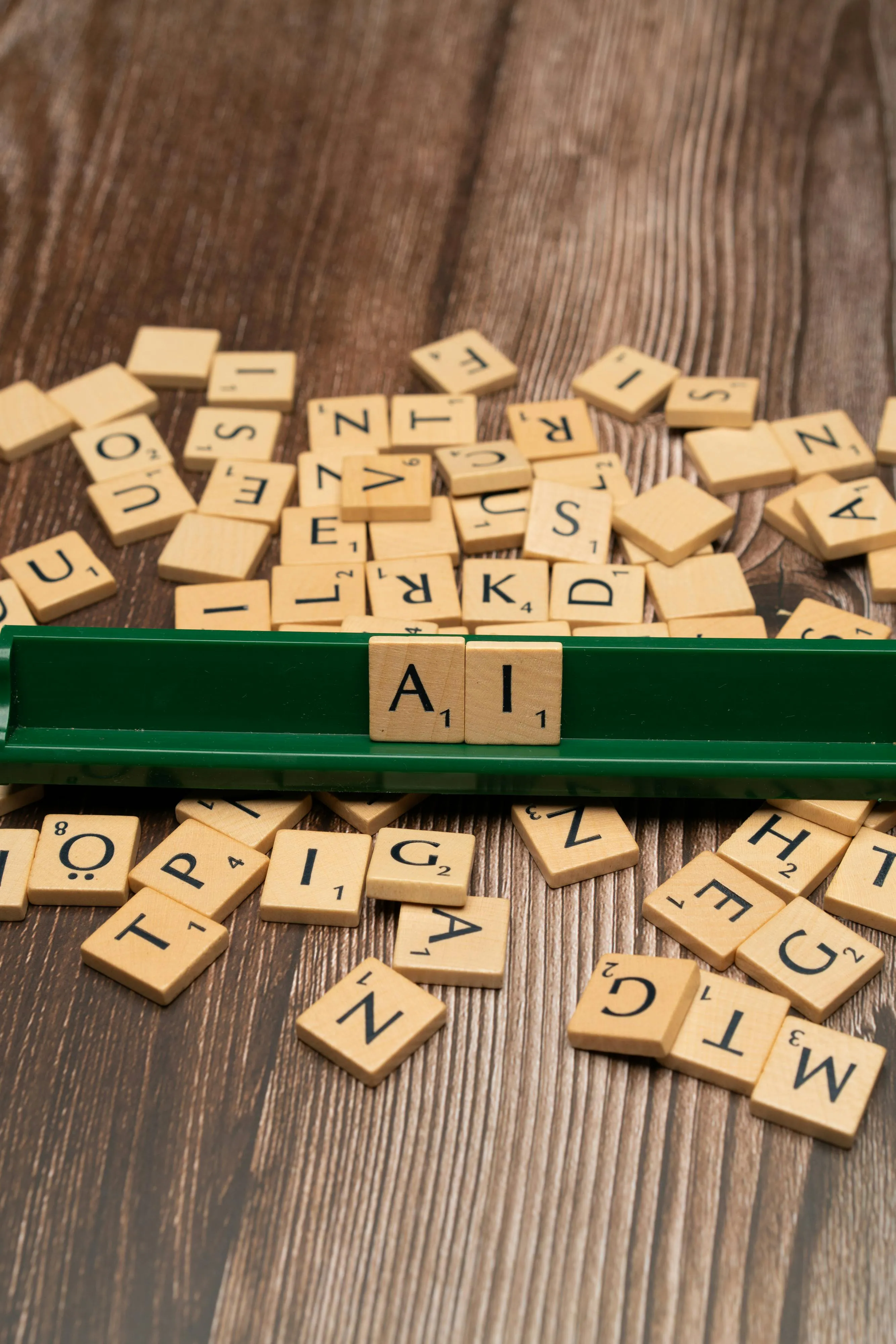 A scrabble tray with the word AI spelled out