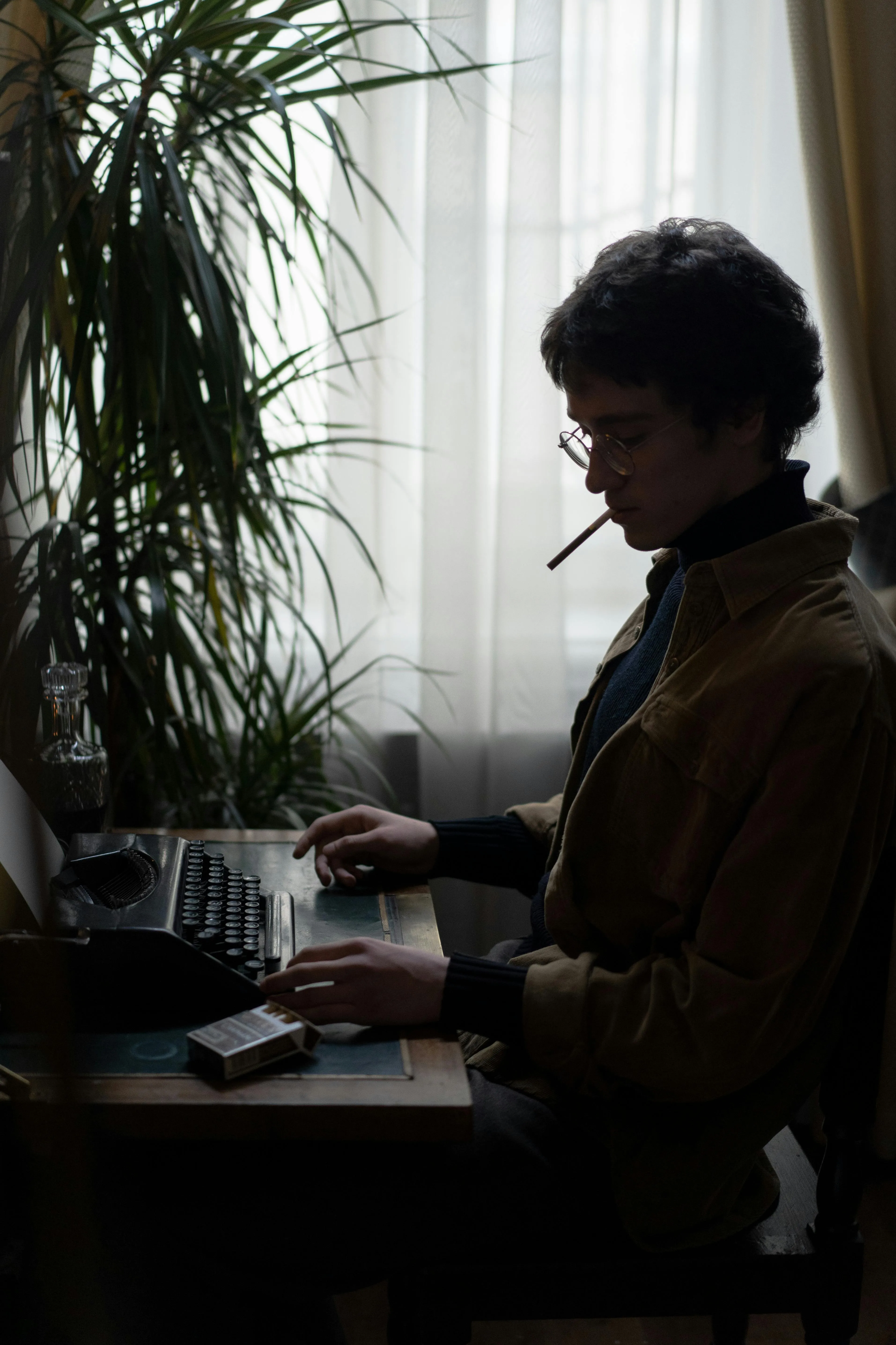 A serious writer working at a desk in the traditional style