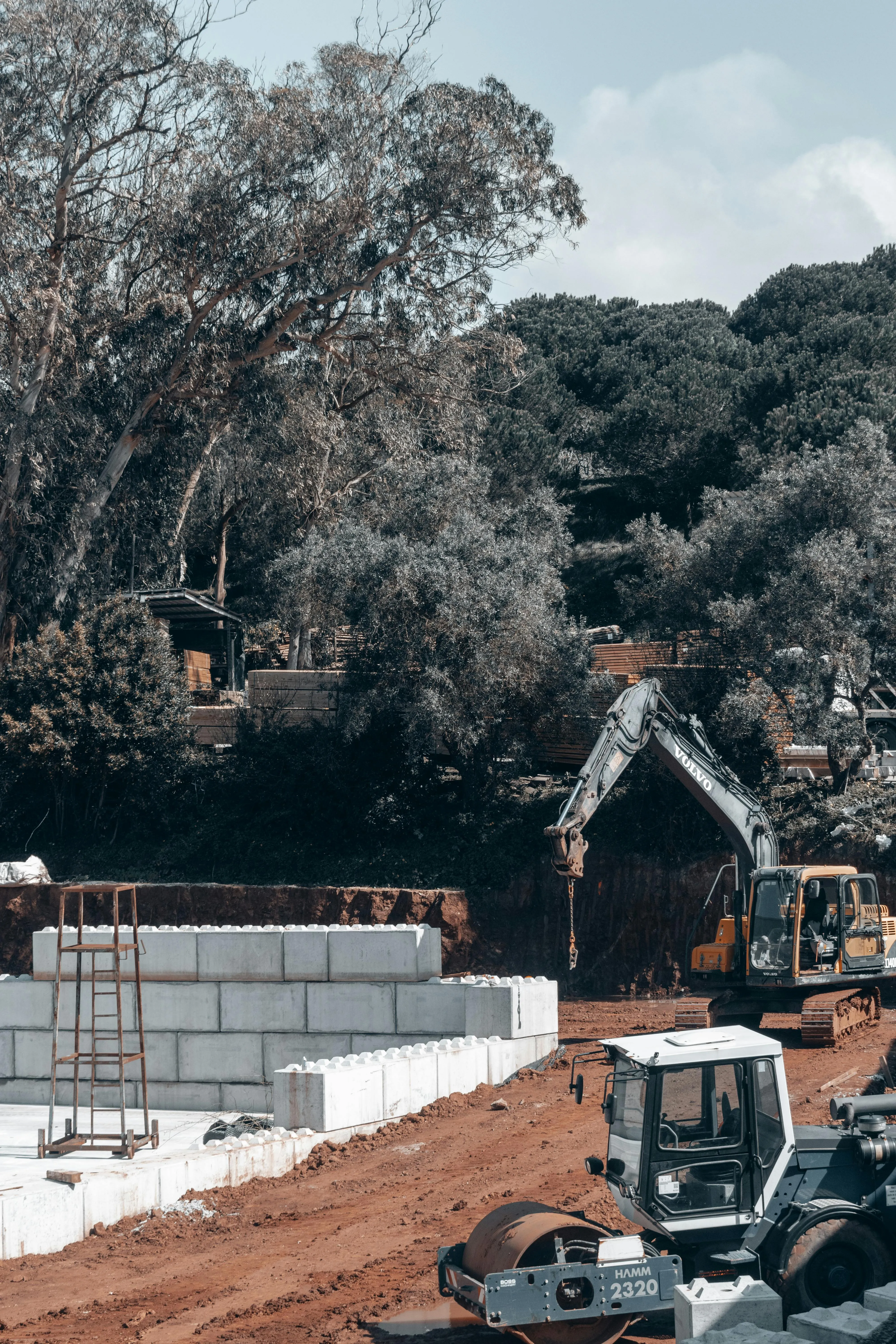 Heavy machines at a construction site, representing a batched production workflow